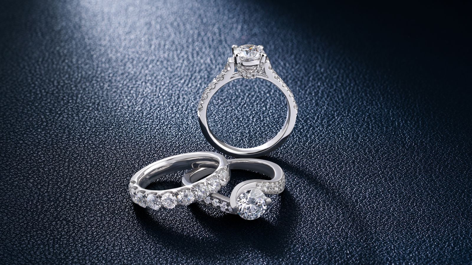 Diamond rings on a dark textured surface