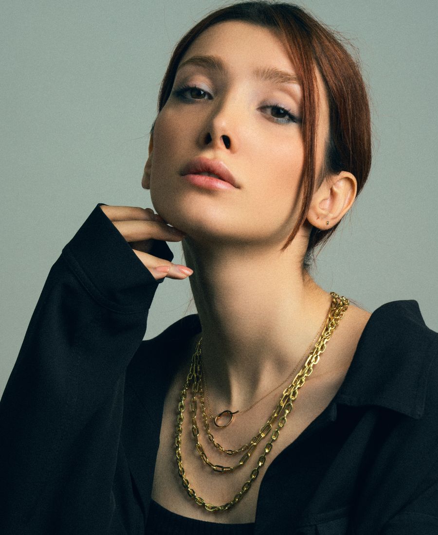 Model wearing layered gold statement jewellery, representing haute couture design