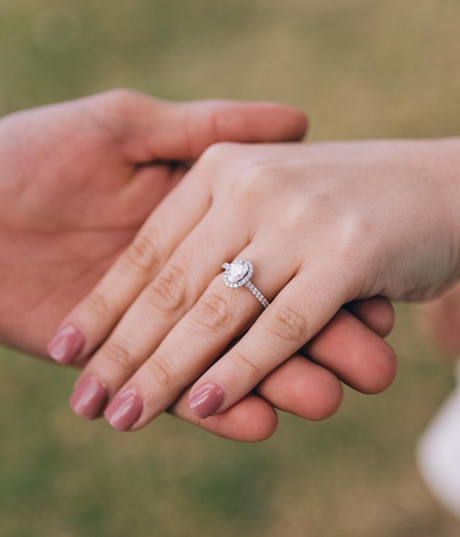 Couple holding hands showing a custom diamond engagement ring